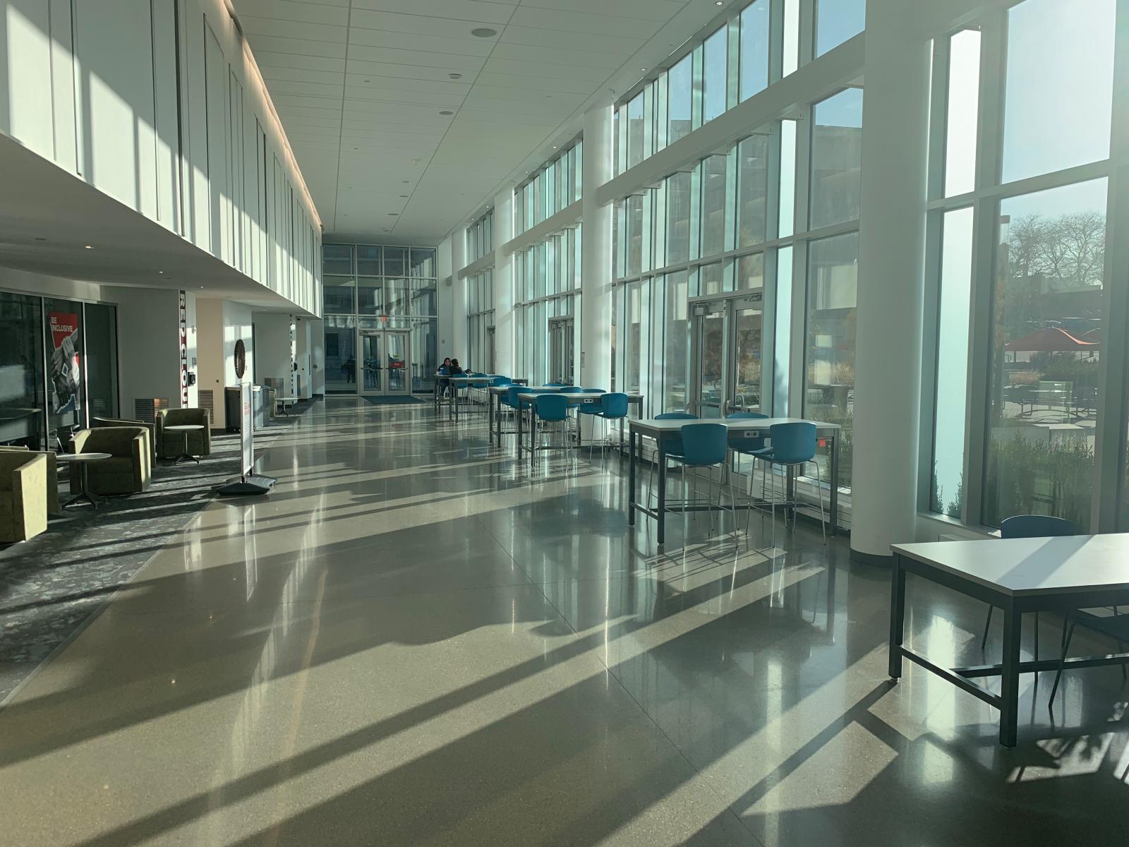 students studying beside large windows in the Willa Cather Dining Center.