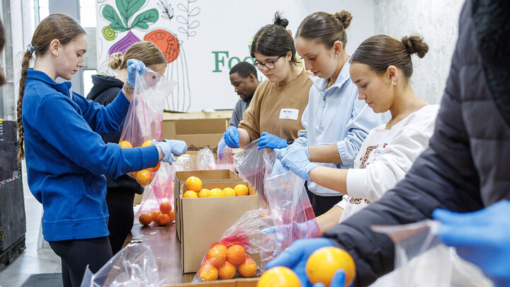 University of Nebraska–Lincoln students place oranges into bags during SLICE’s Engage Lincoln volunteer project at the Food Bank of Lincoln on Jan. 30.