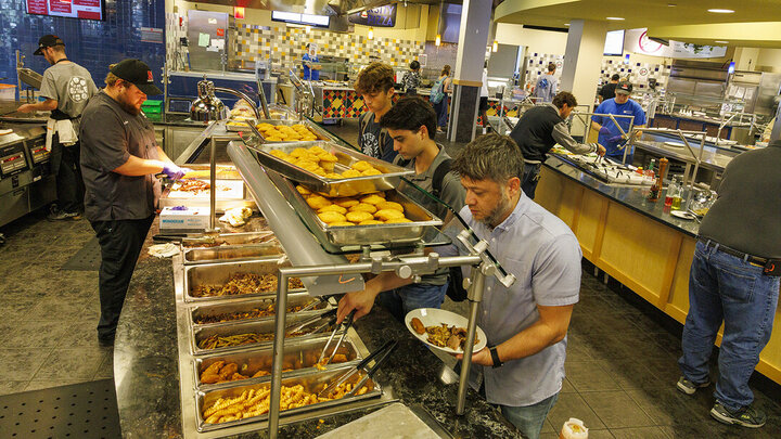Staff and students in line at Harper's Smokehouse inside the Harper Dining Center.