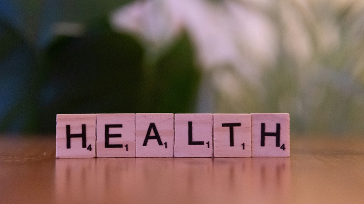 Wooden letter tiles spell Health.
