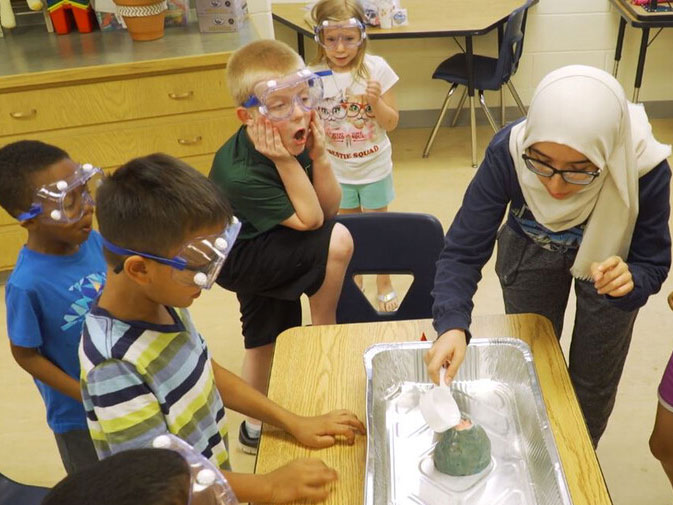 Nora Husein of Lincoln conducts a science experiment during her after-school club in 2019.