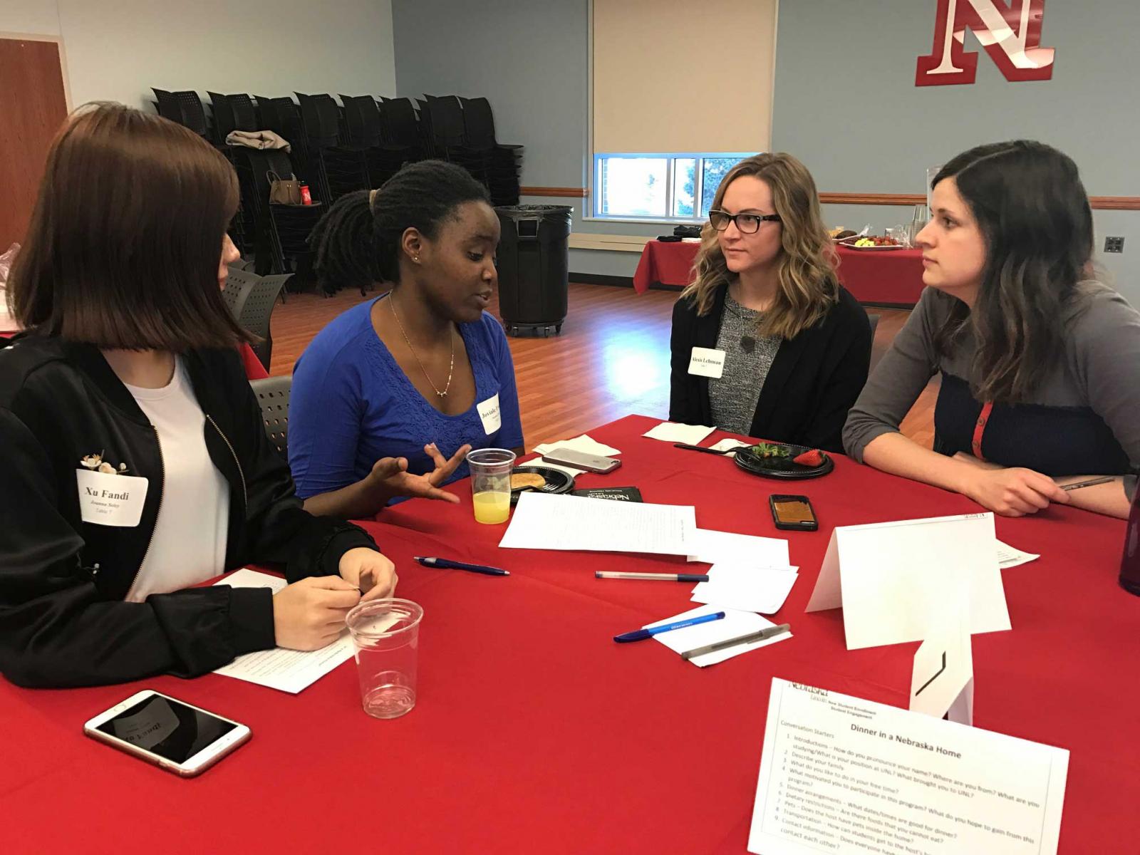 International students and university employees meet to find a time to plan to have a dinner together.