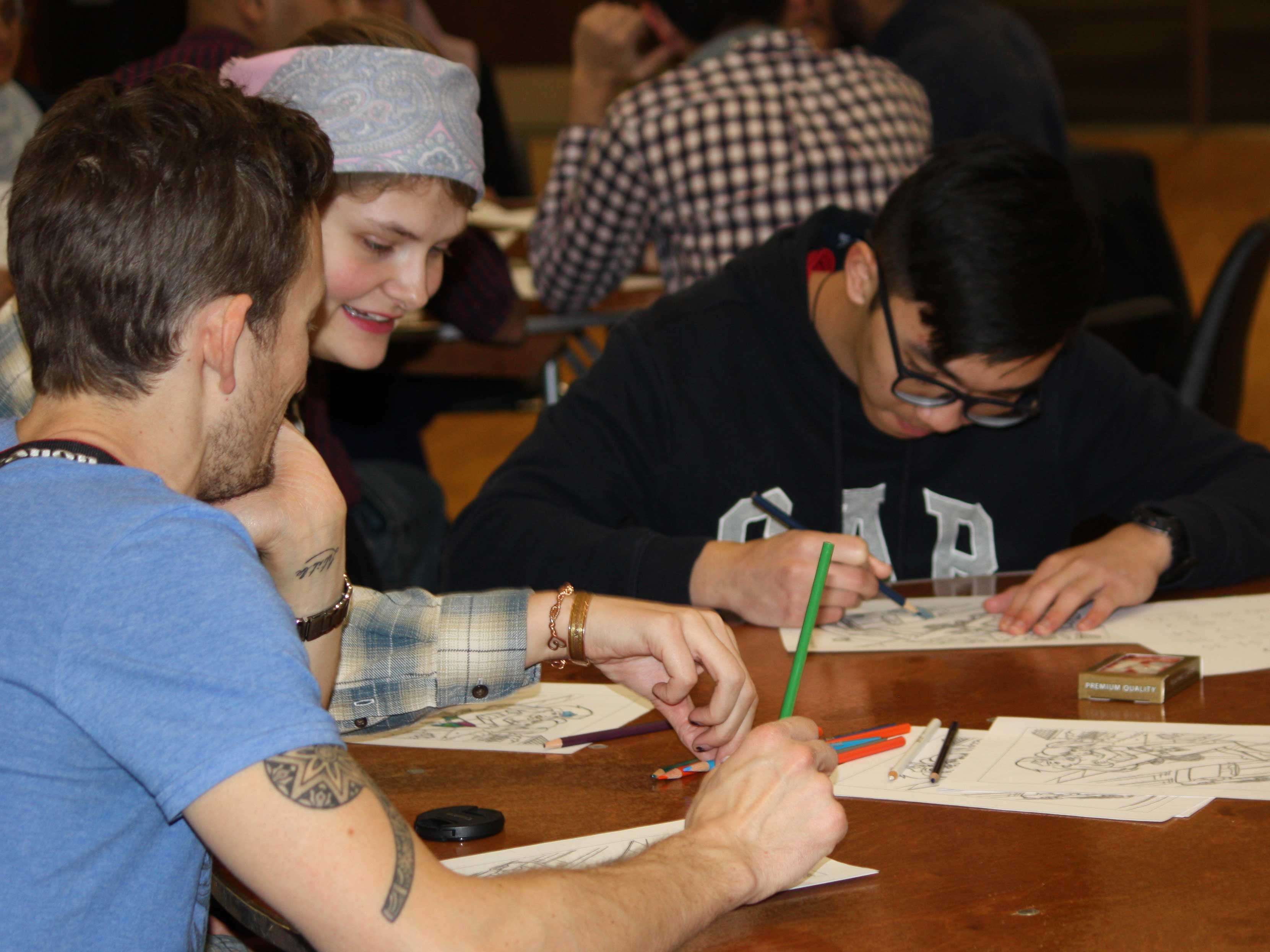 Students color pages from the Women's Center.