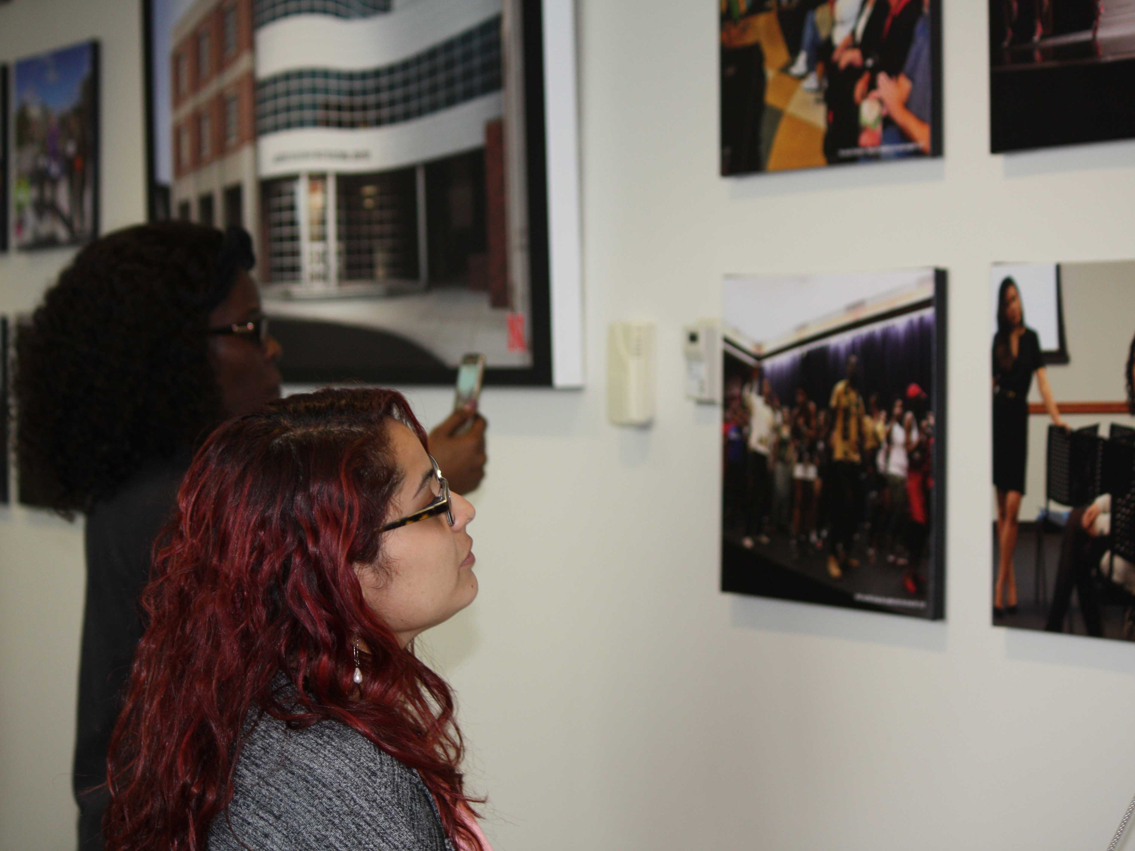 Student looks at photo in Mandala Lounge