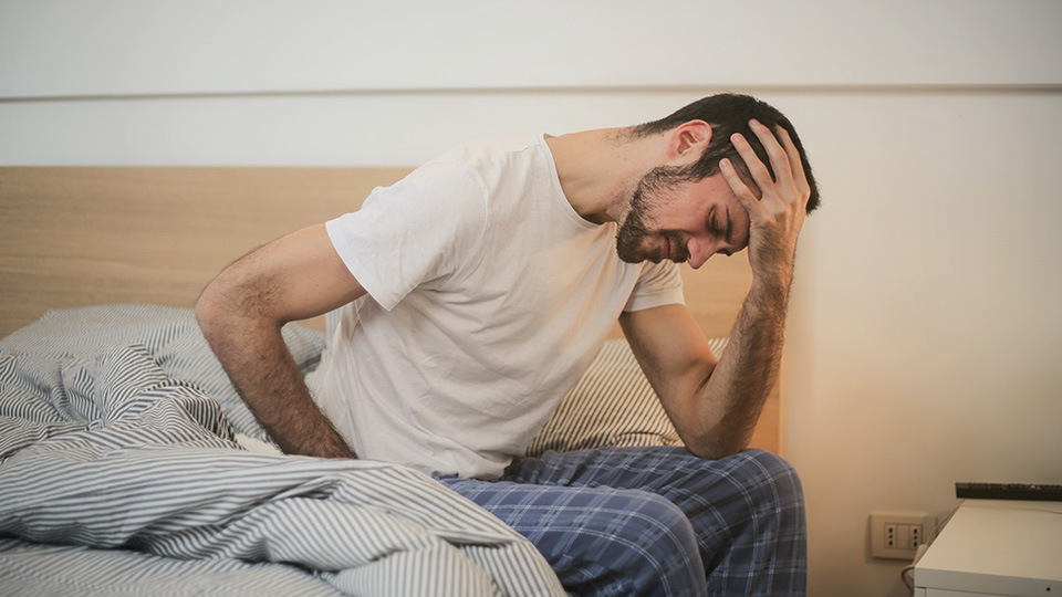 Person that is waking up with headache from cold or flu.
