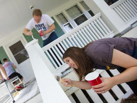 Kate Christensen and Theron Christensen paint porch columns at a house on B Street as part of a citywide Paint-A-Thon Aug. 20, 2016.