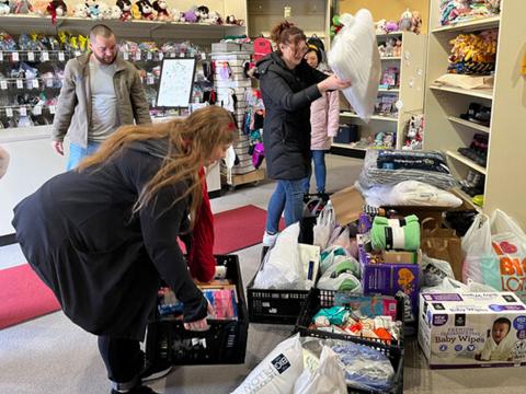 Paul Brown (right) and Tina Pham (left) drop off donations Dec. 16 at the Foster Care Closet.