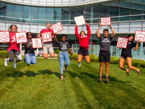 Big Red Resilience and Well-being volunteers pose with the dimensions of well-being that are promoted in the program to provide a framework for exploration and balance.