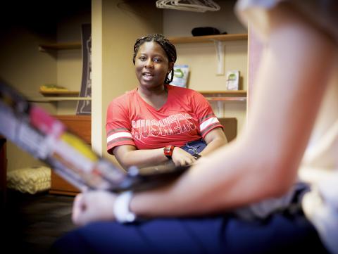 A student chats with her roommate while studying in in their room in the residence hall. [Craig Chandler | University Communication]