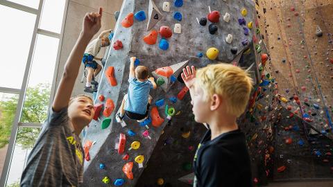 Husker Kids summer camp participants enjoy the rock wall at the Outdoor Adventures Center