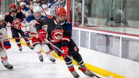 Dylan Mcrae, forward (74), moves the puck down the ice. [Dillon Galloway | University Communication and Marketing]