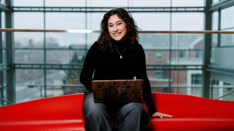 Ritsa Giannakas, a political science and economics major from Lincoln, poses for a photo inside Howard L. Hawks Hall.