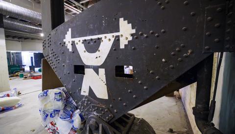 When the women’s locker room was gutted, it revealed the original ironwork for the Coliseum. Stenciled to a girder was a stylized Nebraska weightlifter from when the area was a weight room. Construction continues to renovate the locker rooms and a new weight training and conditioning area. [Craig Chandler | University Communication and Marketing]