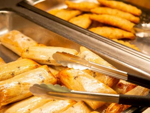 A student serves beef and chicken empanadas at Selleck Dining Hall on Saturday, March 14, 2020, in Lincoln, Nebraska.