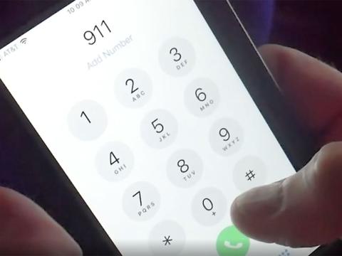 Person dials 911 on phone