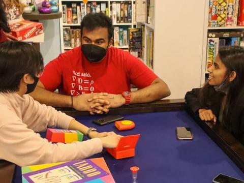 Students play board games with ISSO and Campus NightLife at Mana Cafe