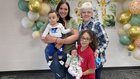 Lory Erving stands with family members during an event at the Cather Dining Center. Erving works at the dining center and strives to make one-to-one connections with students. [courtesy photo]