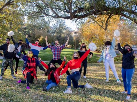 We Are Nebraska performers pose in campus green space