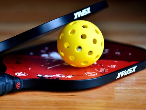 Pickleball paddles and ball. [Photo by Ben Hershey on Unsplash]