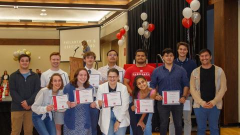 Students receive Husker Volunteer Designation certificates at the Student Impact Awards.