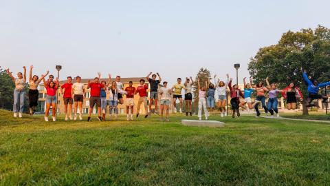 Members of all four Greek councils take a group photo jumping in the air on East Campus.