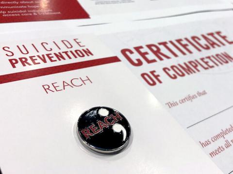 The REACH suicide prevention lapel pin and certificate of completion given to participants who attend the in-person 90-minute training.